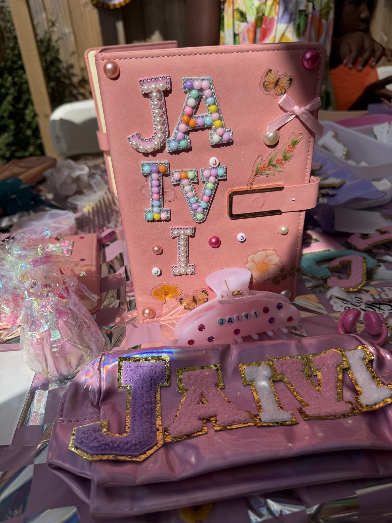 Personalised craft journal decorated with bead and pearl letters at a children's craft party